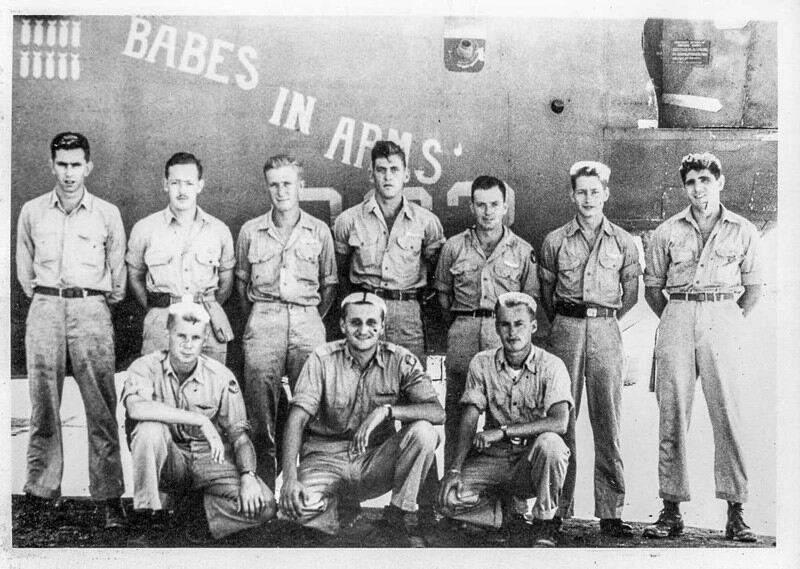 vintage photo of soliders standing in front of a plane