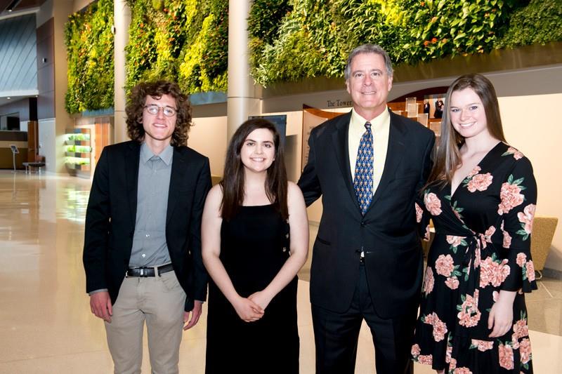 David Plastino with the 2020 Plastino Scholars in front of the living wall in the Tower at STAR. Caleb Owens is standing on the left. 